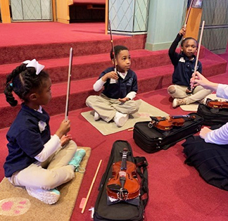 Students learning how to play violin