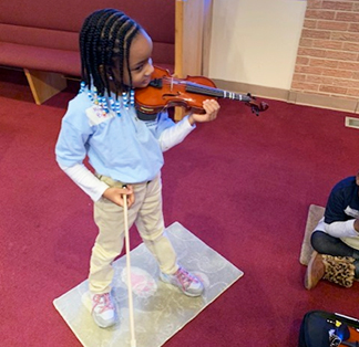 Student standing with violin