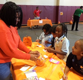 Parent in classroom helping with learning activity