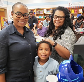 Parent posing for a picture with student