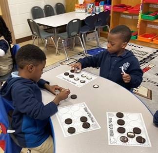 Two boys having fun with cookie learning activity