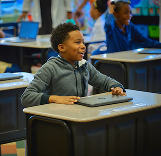 Boy in classroom building with shapes