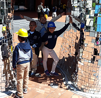Group of students on a field trip and exploring a shiny structure